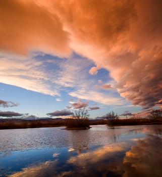 Orange clouds over a river