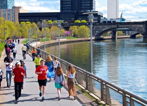 Folks running on a nice day by a bridge in PA