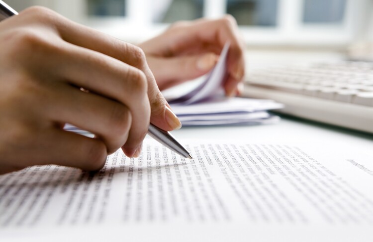 hand holding a pen over paper hand holding a pen over paper